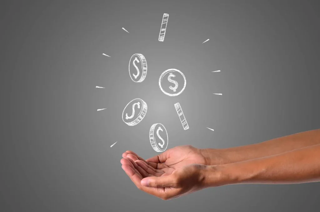 Hands catching falling money coins on gray background