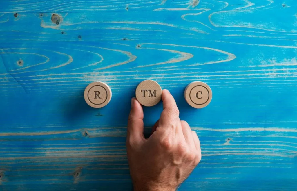 Trademark and copyright symbols on blue wooden background